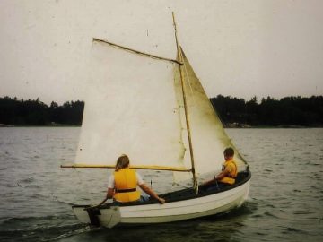 Two young people in a sailing dinghy