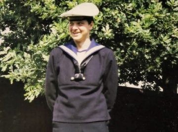 Young man in the garden in Navy uniform.